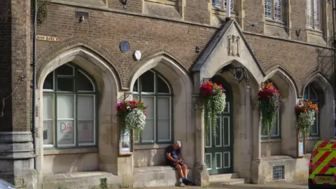 LDRS Town council building with hanging baskets of flowers on outside