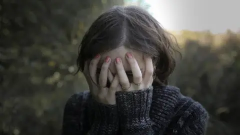 Getty Images Woman breaking down