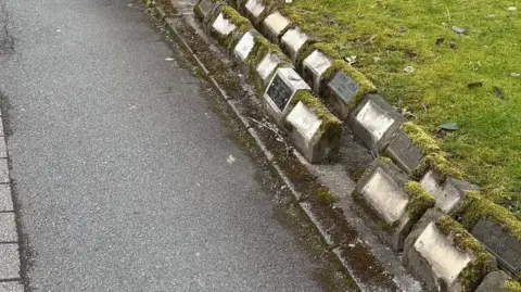Bolton Council Pathway at the crematorium lined with memorial plaques.