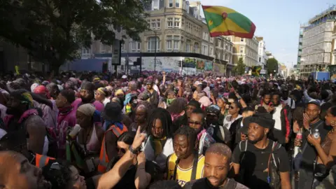 PA MEDIA People attending the Children's Day Parade, part of the Notting Hill Carnival celebration in west London over the Summer Bank Holiday weekend