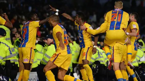 Getty Images Wilfried Zaha of Crystal Palace celebrates his second goal among police during the npower Championship semi-final second leg between Brighton & Hove Albion and Crystal Palace at the Amex Stadium on May 13, 2013