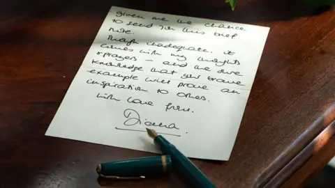 One side of Princess Diana's letter with a pen