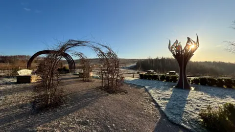 Gedling Country Park is pictured with frost on the ground and bright blue sky