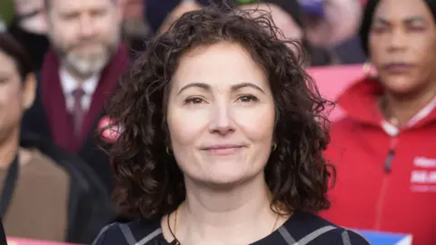 PA Media Angeliki Stogia poses in front of a crowd of local Labour party activists at an event to announce her selection.