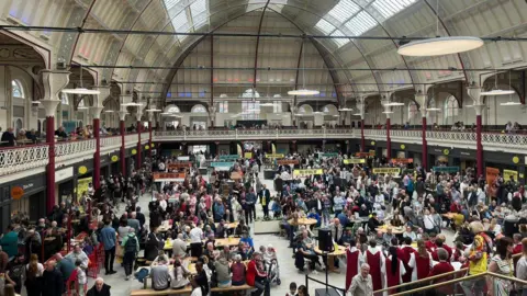 Large crowds inside a newly-refurbished Derby's Market Hall taken from the top terrace. 