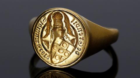 Gold ring with a seal printed on it
