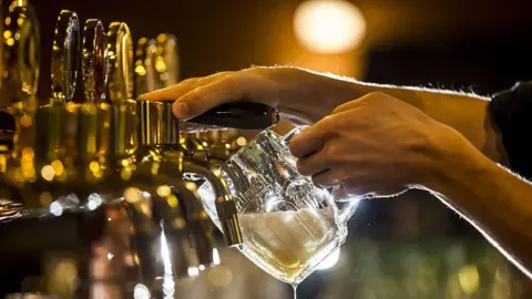 Getty Images Beer being poured out in a pub in the Czech Republic.