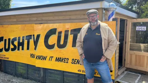 Nathan Scotford outside his barber shed