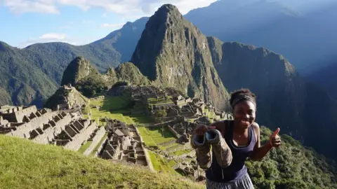 Supplied A woman standing in Machu Picchu with a mountainous landscape stretching across the background