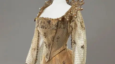 The bodice of a gold gown worn by Queen Alexandra.