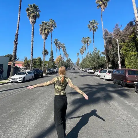 Freya Ridings Freya Ridings stands in the middle of a street lined with palm trees in Los Angeles. The sky is clear blue and she's stretching out her arms, with a sense of freedom