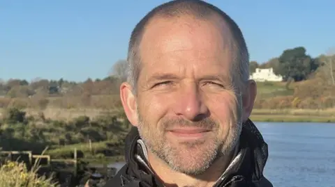 RICHARD DANIEL/BBC Michael Strand from Suffolk Wildlife Trust standing next to the River Deben  