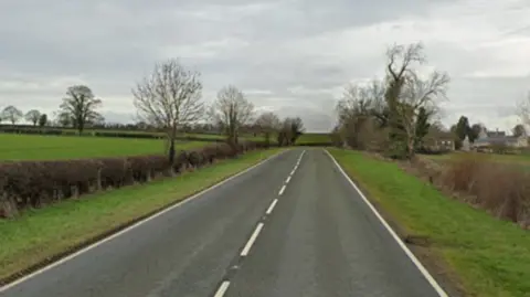 Google Google street image of a single carriageway road with fields either side.