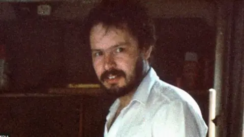 PA Media An old, grainy image of a man with brown hair and a beard 