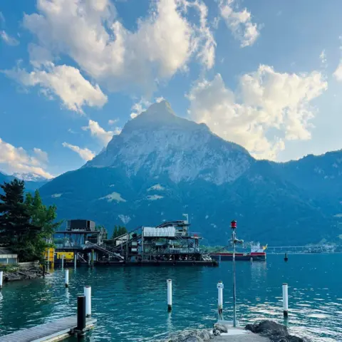 Byrne family Mountain -  Gitschen mountain - in Switzerland, with water in the foreground.