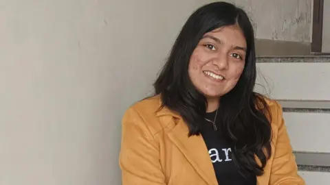 Kashish Barot Smiling Kashish Barot in a suede-coloured jacket