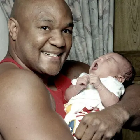 Michael Brennan/Getty Images Foreman holding his baby son George III