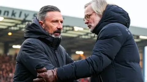 Heart of Midlothian head coach Derek McInnes and Dundee counterpart Steven Pressley shake hands
