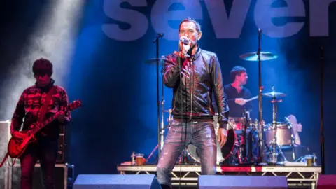 Rick Witter singing on stage with Shed Seven at Bingley Music Live in 2014 