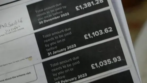 A black and white piece of paper with figures on showing the monthly energy costs. The highest figure on the piece of paper is shown as £1381.28.