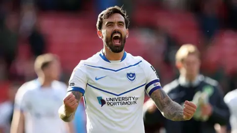 Marlon Pack celebrates after Portsmouth win a game