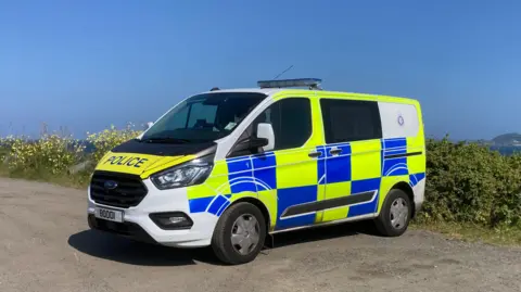 A large blue and yellow police van. 