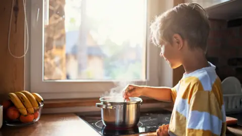 Getty Images Child at stove top