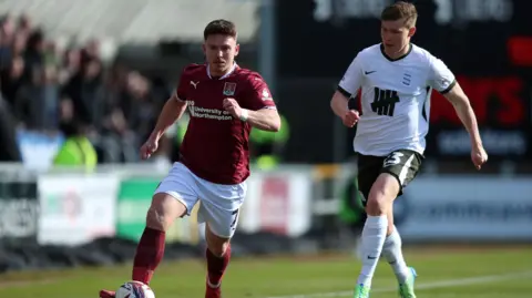PA Media Northampton Town's Sam Hoskins battles for the ball against Birmingham's Alfons Sampsted during the Sky Bet League One match at Sixfields Stadium, Northampton