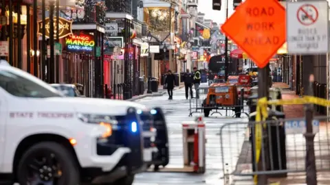 Law enforcement members work at the site where people were killed by a man driving a truck in an attack during New Year's celebrations, in New Orleans.