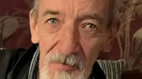 A man with a grey beard.