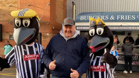 Freya Katherine Morgan Hillary Man with two magpie mascots
