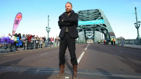 PA Sting poses for photographers on the Tyne Bridge before starting the Great North Run in Newcastle in 2009