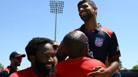 Getty Images Saurabh Netravalkar of the USA celebrates his victory with teammates during the ICC Men's T20 Cricket World Cup West Indies & USA 2024 match between the USA and Pakistan at the Grand Prairie Cricket Stadium on June 06, 2024 in Dallas, Texas