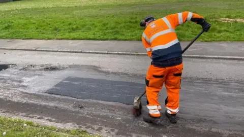 BBC Worker fixing a pothole 