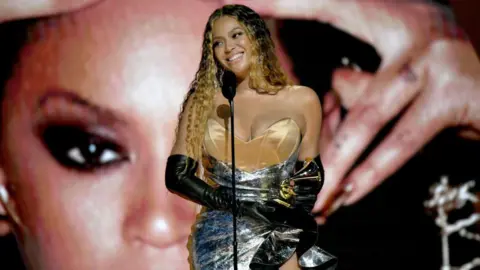 Getty Images Beyoncé accepts a Grammy Award in 2023