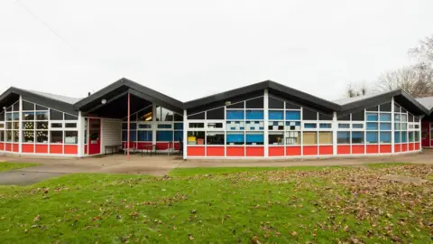 School building with lawn in foreground