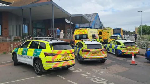 The BBC police car and ambulant vehicle is outside the queen Elizabeth Chozabeth