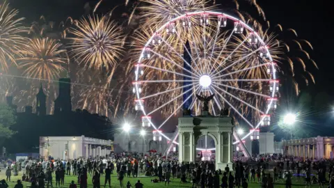 People watch a fireworks display that is attempting the largest firework display in history with 850,000 fireworks 