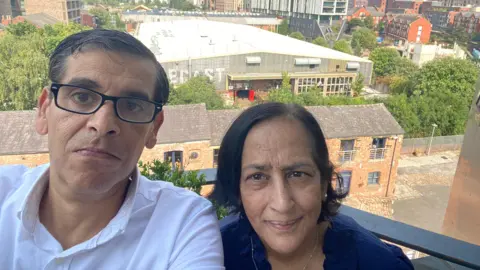 Maged and Meena take a selfie on their balcony with the venue in the background.