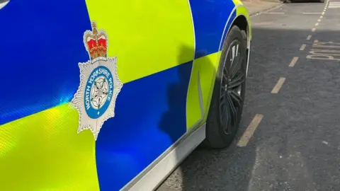 A North Yorkshire Police car in a parking space