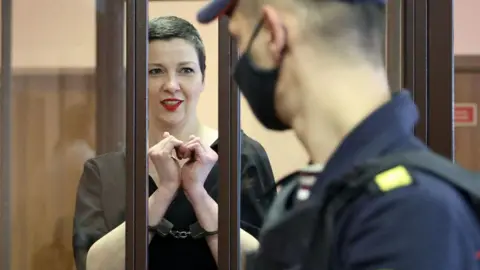 RAMIL NASIBULIN/BELTA/AFP Maria Kolesnikova, the last remaining protest leader in Belarus, shows emotion inside the defendant's cage during her trial on charges of undermining national security, plotting to usurp power and creating an extremist group. September 6, 2021 in Minsk.