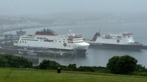 The Manxman in Douglas Harbour alongside the Ben-My-Chree in Douglas Harbour on a rainy day.