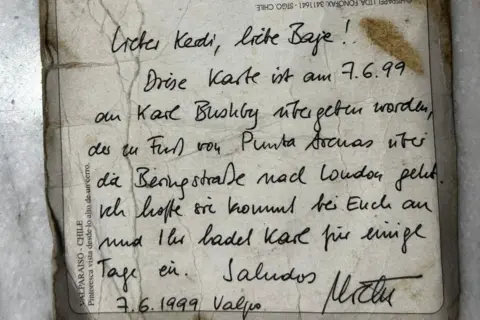 Karl Bushby A postcard showing German writing that translates to "Dear Kerdi [a nickname]. This card was given to Karl Bushby on 7.6.1999, who is walking on foot from Punta Arena via Bering Strait to London (sic). I hope it arrives with you and you invite Karl for a few days. Greetings, Michael."