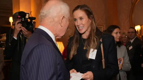 Getty Images/Yui Mok King Charles III speaks with Helen Glover during a reception for medallists from the Paris 2024 Olympic and Paralympic Games at Buckingham Palace on 7 November 2024.