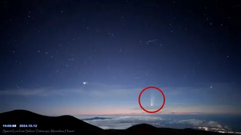 A comet is seen passing through the sky.