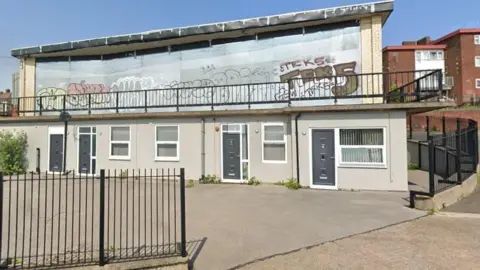 Google View of the boarded-up windows of the closed Byard's Leap pub covered in graffiti