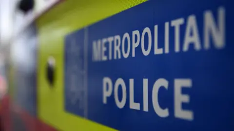 A close-up of the side of a Metropolitan Police van