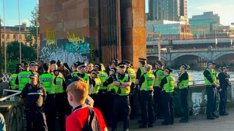 About 30 police officers gathered together 