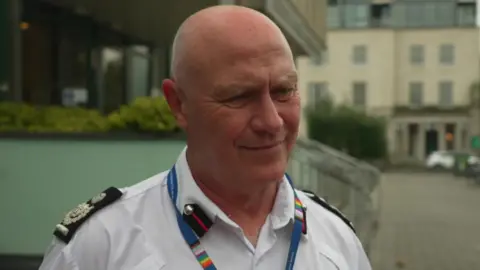 Gerald Taylor from Devon and Somerset Fire and Rescue Service stood outside Plymouth Crown Court wearing a white shirt and looking away from the camera. 