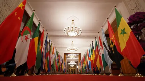 Getty Images The flags of Africa and China lined up down a red carpet at the Great Hall of the People - Wednesday 4 September 2024